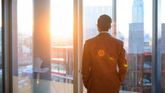 business man looking out window